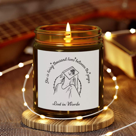 Book Lover Candle, 'She is living thousand lives between the pages, Lost in Words' with a girl and book illustration - amber jar candle for bookworms – cozy literary gift for readers and bookworms.