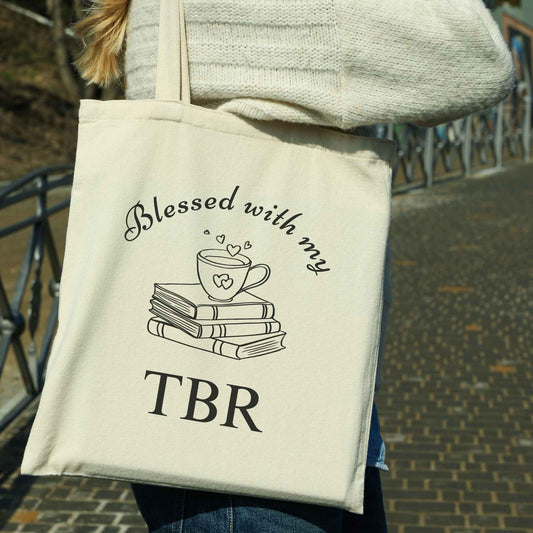 Book Lover natural canvas tote with 'Blessed with my TBR' text and book illustration. Perfect literary gift for readers, journals, and bookworms.
