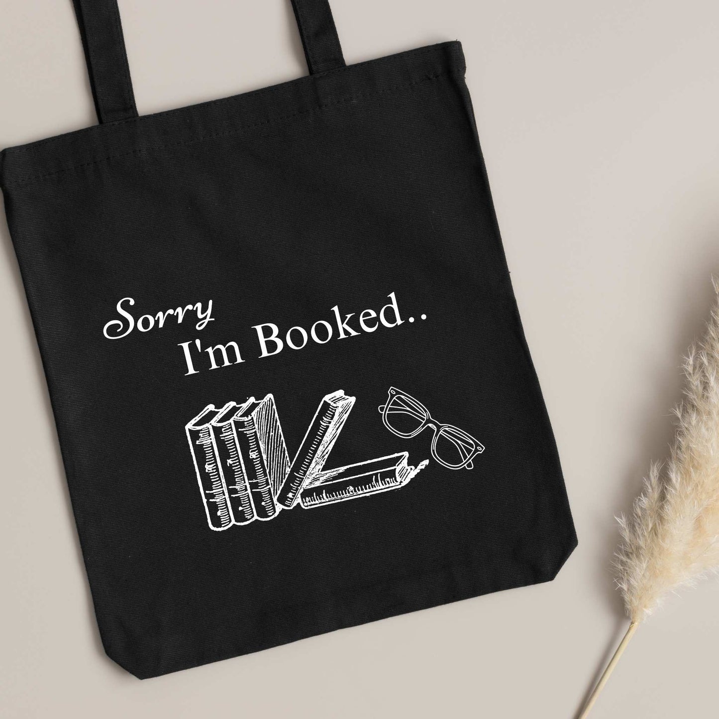 Funny black tote bag with 'Sorry I’m Booked' design – perfect bookish gift for readers and book club members.