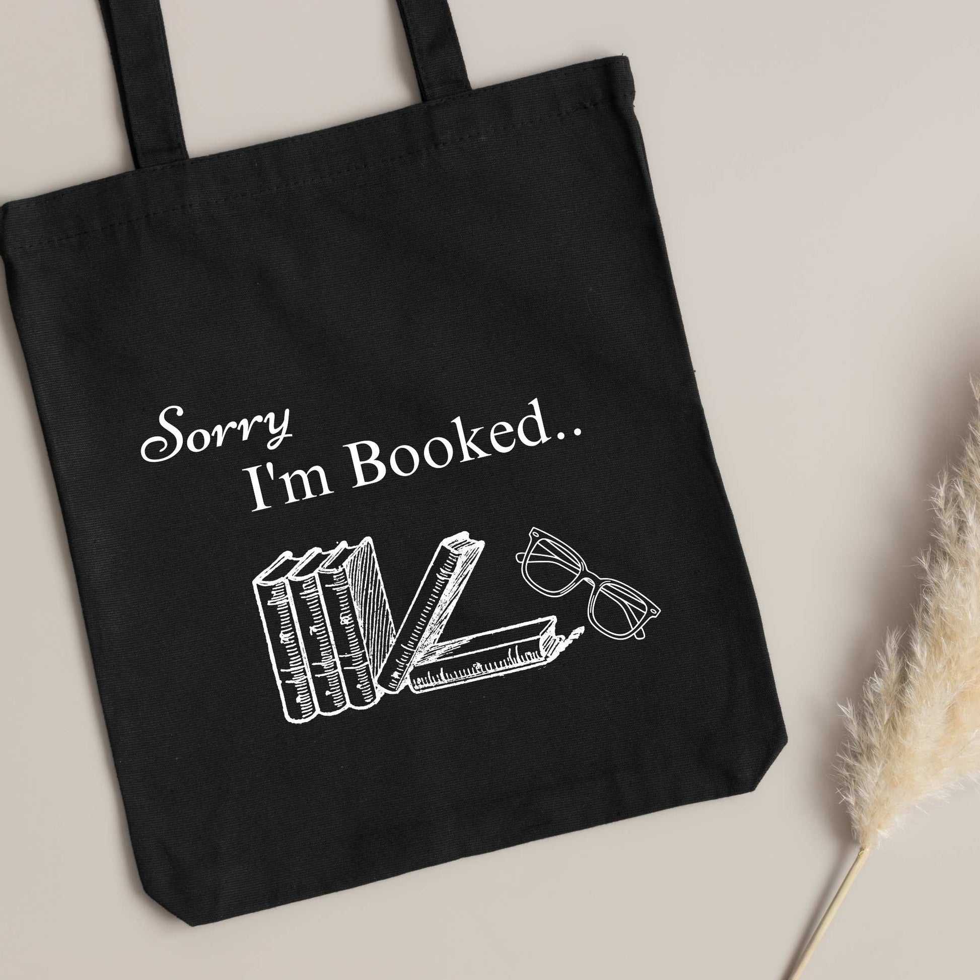 Funny black tote bag with 'Sorry I’m Booked' design – perfect bookish gift for readers and book club members.