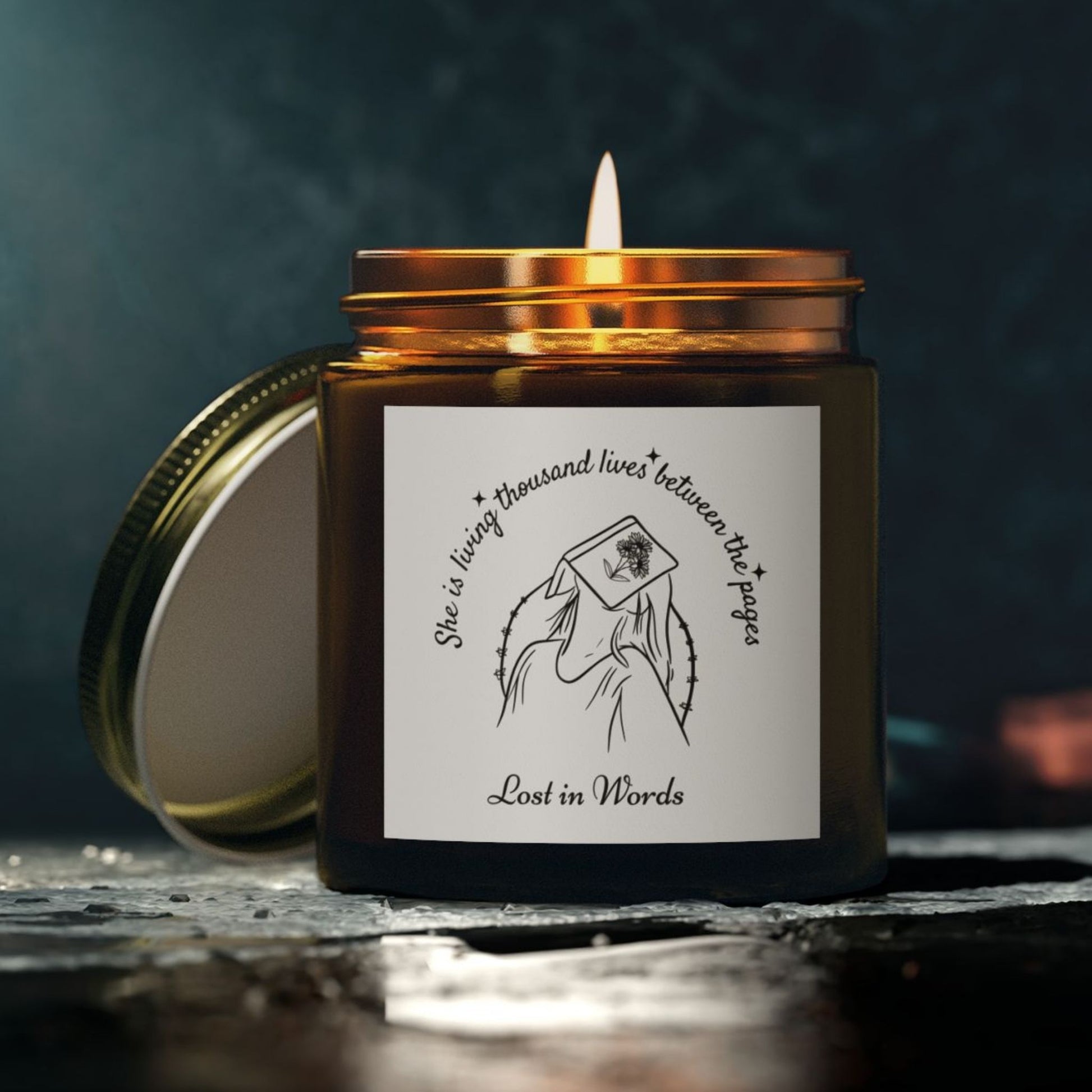 Bookish candle with reading quote – 'She is living thousand lives between the pages, Lost in Words' amber jar decor for home library.