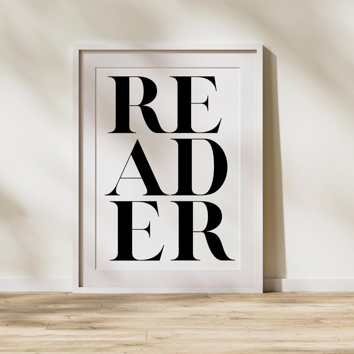 Framed artwork with the word 'READER' on a white background - literary gift for book lovers and reading enthusiasts.