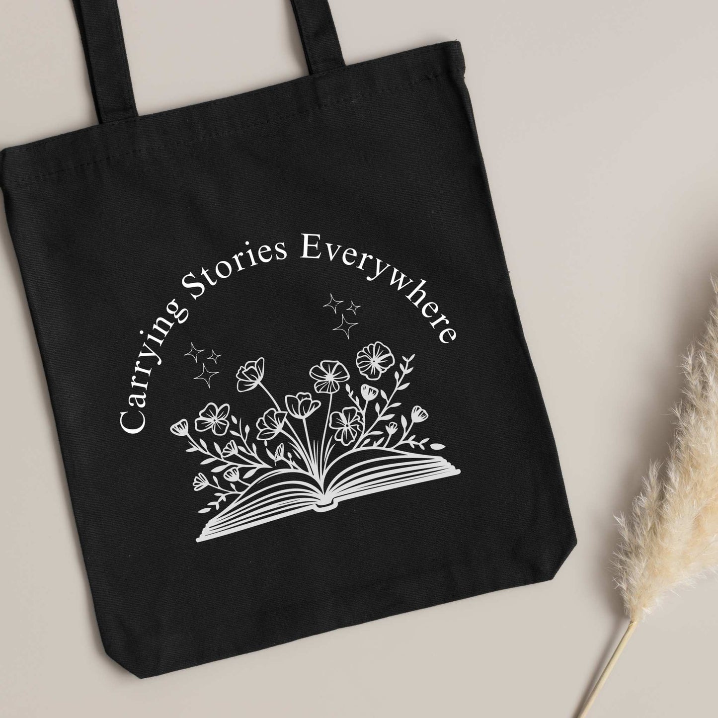 Book Lover tote bag – 'Carrying Stories Everywhere' design on black canvas, cute gift for readers & librarians.