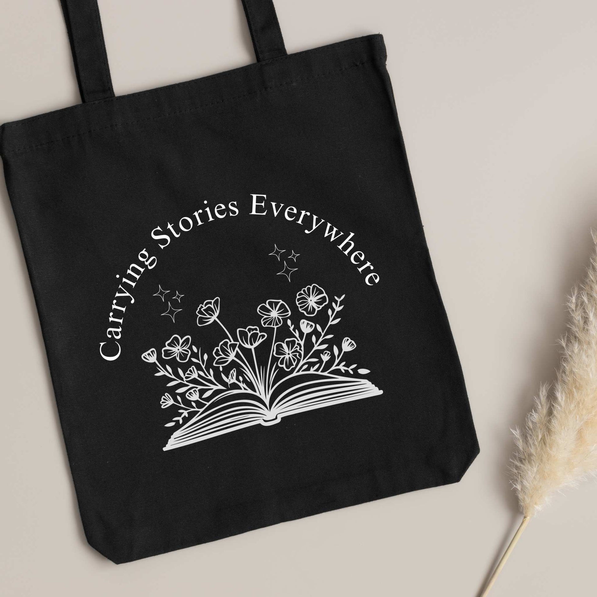 Book Lover tote bag – 'Carrying Stories Everywhere' design on black canvas, cute gift for readers & librarians.